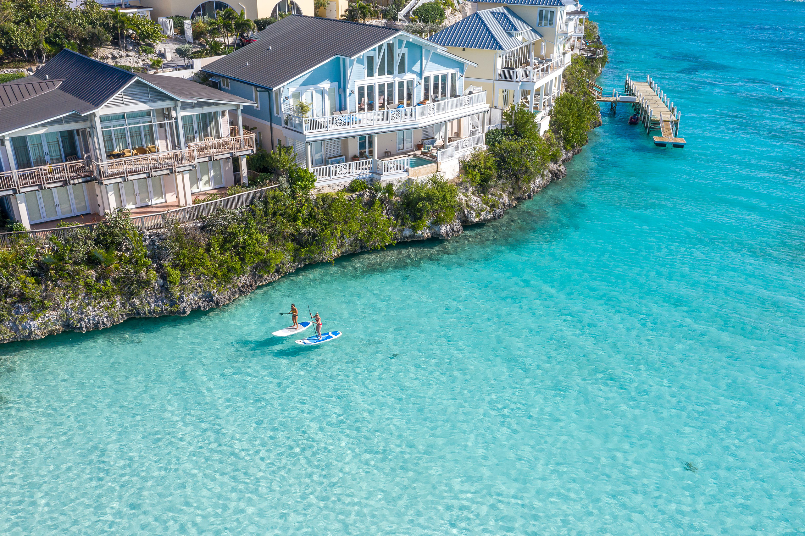 Couple paddle boarding in The Abaco Club Bahamas