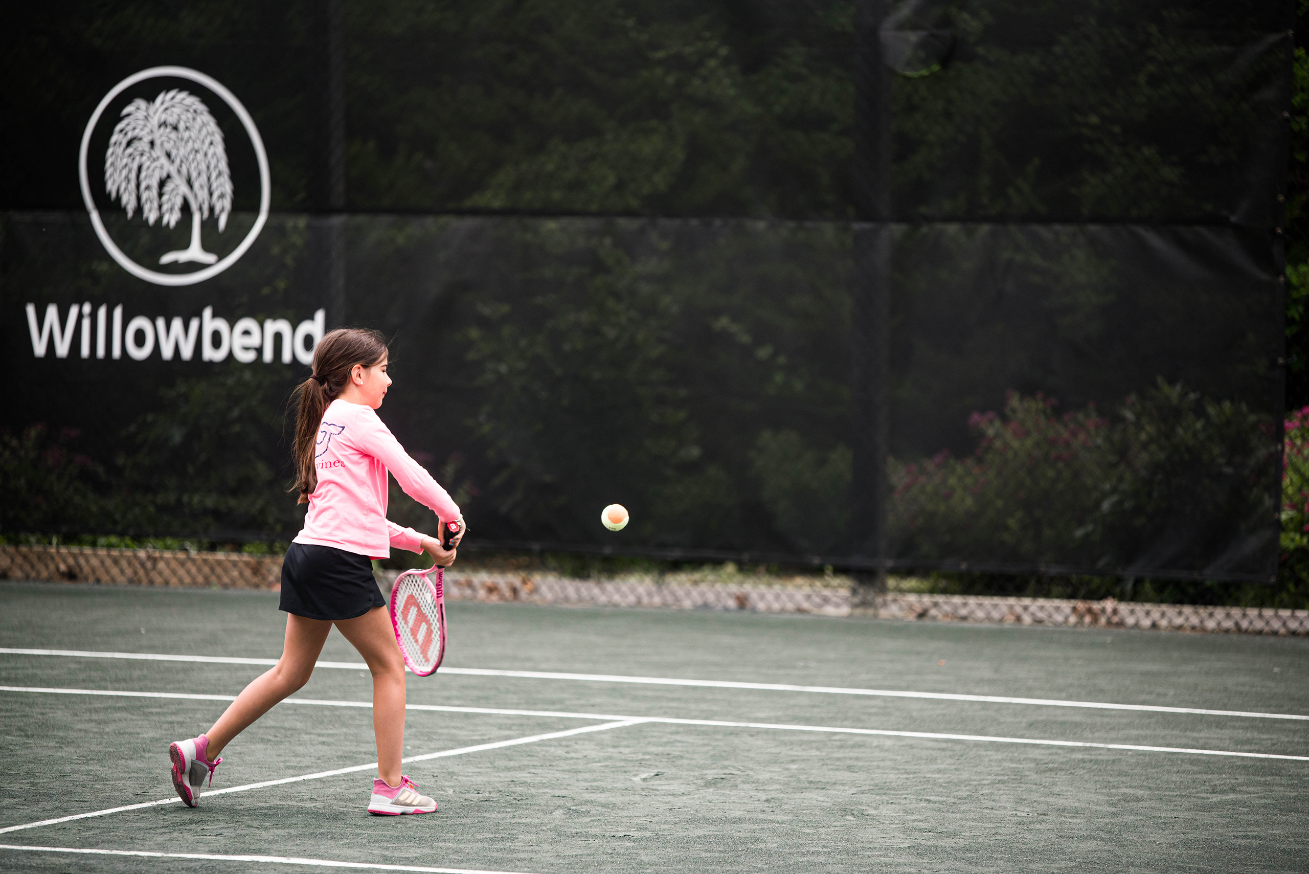 Young girl playing tennis at Willowbend