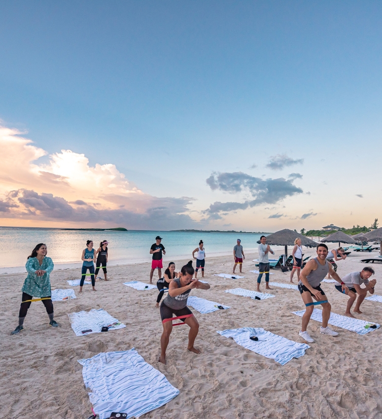 People doing Yoga beach at The Abaco Club